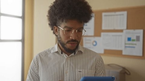 clip-3989734189-man-office-focused-on-tablet-work-charts