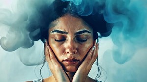 Download A woman with a peaceful expression places her hands on her face, surrounded by swirling blue and gray smoke. This moment captures deep contemplation and emotional intensity in high resolution. for free