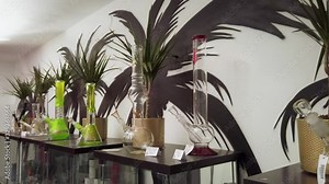 Weed bongs and stacked up in a CBD shop. Drug paraphernalia used to smoke marijuana, display of various large glass pipes