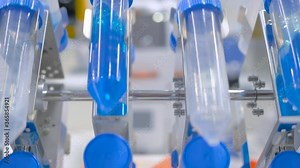 Digital tube rotisserie rotator for effective mixing biological samples at pharmacy factory, medical exhibition: close up. Chemistry, pharmaceutical, laboratory equipment concept