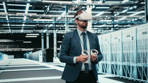 clip-4010792495-data-center-computer-scientist-uses-vr-headset
