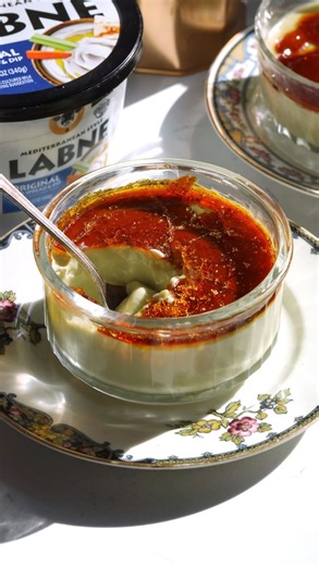 Pistachio Baked Labne Brule...a spin on bhapa doi but with my lil cherry on top. I'm using @karoundairies OBVIOUSLY because it is creamy, luxurious, rich & tangy ❤️. Pro tip: you can also add sugar and brulee it, I just wanted that thick hard candy coating for this! Ingredients: * 1 1/4 cup Karoun labne * 1 cup condensed milk * 2 cups heavy cream * 1/4 cup pistachio cream (sweetened) * Pinch of salt * 3/4 cup sugar * 1/4 cup water Directions: 1. Whisk together the heavy cream, labne, cream of pi