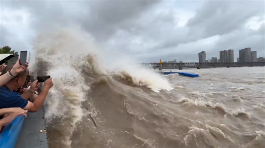 Wave from river splashes over camera during recording