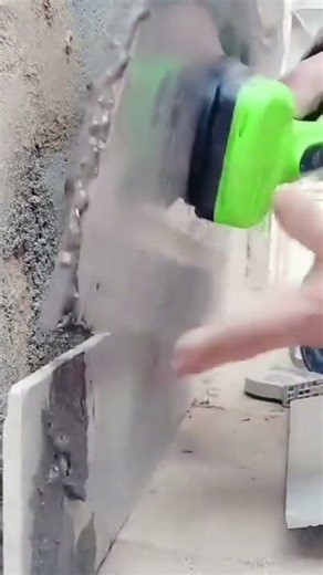 the process of installing ceramic tiles on the outer wall is carried out by a builder