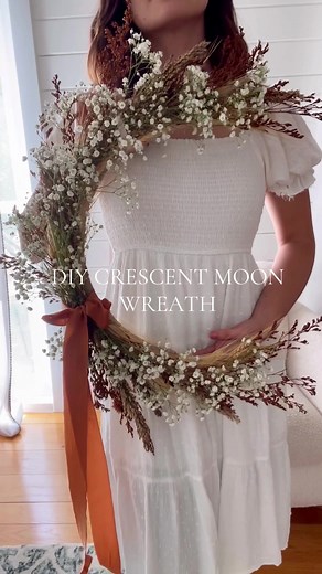 You have to try my favorite fall craft that I love to share every year! This crescent moon wreath is a simple and easy diy and looks so beautiful with your autumn decor. 🍁 I used a wire wreath form cut to shape and florals from Trader Joe's! You could add dried orange slices 🍊, moss, mushrooms and more #fallcrafts #falldecor #falldiy #tiktokcrafts #crafting fall wreath wreath, wreath diy, moon wreath, cottage core aesthetic, home decor academia, dark academia, light academia
