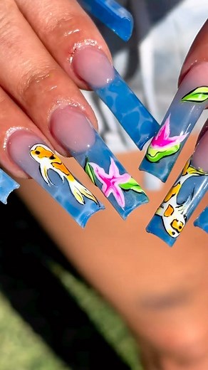 60K views · 222 reactions | Going with the flow with this mesmerizing water nail set  Who needs a fish tank when you can have these koi swimming on your nails? 冀 | nail tech @noeliathenailplug | #nailpro #bluenails #waternails #jellynails #ombrenails #frenchnails #taperedsquarenails #koifish #handpaintednailart #handpaintednails #losangelesnailtech | Nailpro | Facebook