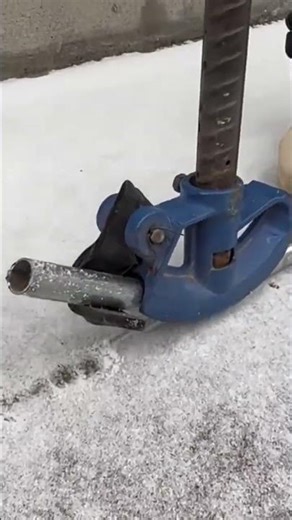Skilled Technician Operating Blue Manual Tool To Bend Metal Pipe
