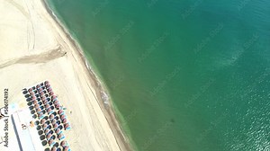 Aerial view of a blue sea water background and sun reflections. Aerial flying drone view. Waves water surface. Flight over the ocean. Aerial ocean view. Top fly over the sea.