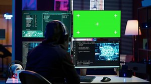 Cybercriminal using AI machine learning and isolated screen PC to develop system exploits. Hacker using artificial intelligence tech and mockup monitor to build script tricking firewalls, camera A