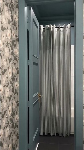 This bathroom makeover includes this beautiful striped shower curtain and washable liner