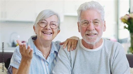 Sixty years couple, elderly parents communicates with grown up children using modern technologies makes video call, wave hands gesture of hello or goodbye sign, older generation and internet concept