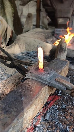 Watch how a skilled blacksmith hand-forges nails from old iron by hammering it into shape."