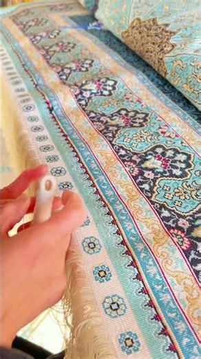 The weaver was skillfully hand knotting the fringes of the handmade silk carpet in Yilong workshop.