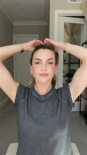 Twist & Tuck Messy Bun 💁‍♀️ Start with your hair in a high ponytail, secured with a hair tie. Split the ponytail into two sections and fan the hair out over the hair tie. Place a stretchy hair tie over the fanned-out sections, securing them in place. Take a small section of hair, twist it a couple of times, and tuck it into the stretchy hair tie. Repeat this step, working your way around the bun until all your hair is tucked in. Gently adjust and fluff the bun to achieve your desired messy look