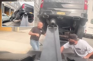 Wild video shows furious driver speed off in stolen tow truck — with his vehicle attached — while unleashing mayhem down street