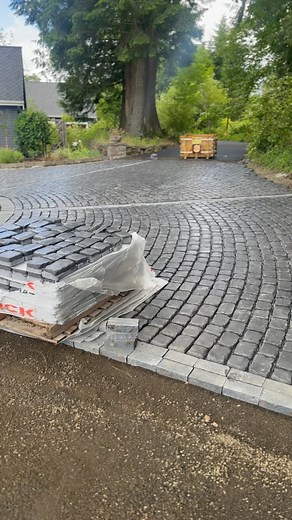 ‼️DREAMY‼️Just can’t get enough of this circular cobblestone driveway! What do you think? I think it was worth getting pavers from @unilock trucked in from Chicago! You wanna turn heads, you gotto make big moves! This client has amazing vision and we are thrilled to bring this to life for them! | Mainstream Landscape