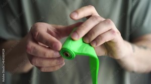 roll of bags for dogs. A man holds a roll of poo bags in his hands. Dog waste bags. Eco-friendly bags for animals. Green waste bags