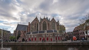 Amsterdam Netherlands time lapse, city skyline at canal waterfront and Oude Kerk Amsterdam