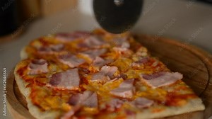 girl making Italian pizza at home, adding pizza ingredients and pizza sauce to the pizza