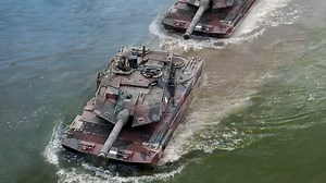 German Leopard tanks maneuver through river during intense training exercises