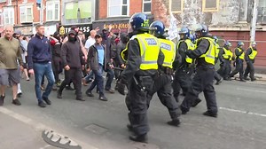 Officers were forced to retreat down a road to get away from the assembled group of protesters.