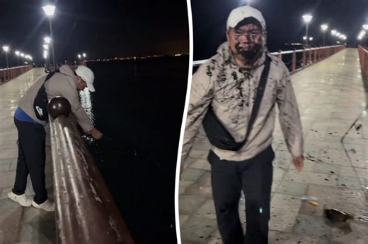 Squid gets revenge by squirting ink all over fisherman’s face