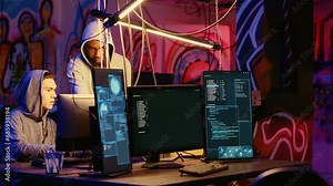 Malicious computer specialists in secret abandoned warehouse working together to get past anti tamper measures implemented by companies to protect their software, uploading crack to torrent websites