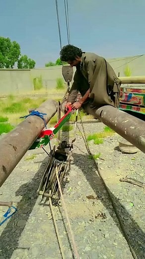 Traditional Water Pump Operation in Rural Setting