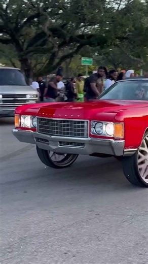 Red 71 Chevy vert on 26’s riding thru