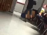 Student kicks a chair from underneath classmate during Pledge