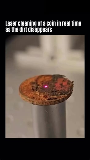 unseen on Instagram: "The clip shows laser cleaning of a coin. As the beam scans the surface, the thin contamination layer (dust, oils, tarnish, oxides) absorbs more energy, heats up, and vaporizes. The coin’s base metal reflects much of the light, so with correct settings it sees minimal heating. This is typically done with pulsed infrared fiber lasers around 1 µm and very short pulses, delivering energy briefly and precisely for a selective effect — the dirt is removed while the metal remains.