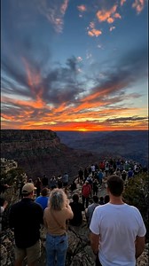 GRAND CANYON SUNSET MAGIC — Mather Point Crowds 🌅🗽🇺🇸 Mather Point on Grand Canyon's South Rim draws massive crowds for epic sunsets, where fiery orange skies illuminate 277-mile-long red rock layers as the sun dips west, transforming cliffs into glowing crimson and gold. This prime viewpoint, steps from the Visitor Center, offers panoramic vistas of the Colorado River gorge ~1 mile deep. Sunset ~17:15 MST in December; arrive 45min early to claim rail space amid 200 visitors.​​ Top Viewing Sp