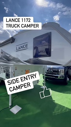 A Truck Camper with a side entry and a sofa! This Lance model 1172 is a 4 season truck camper with a full bath! #thecampoholics #truckcamper #camper #trucking #camper #camperlife #lance #HersheyRVShow #rvshow #camping #newrv | The Campoholics