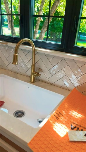 Herringbone tile backsplash installation
