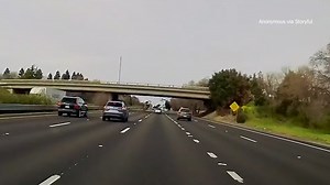 Video: Vehicle launches off overpass, plummets onto freeway below