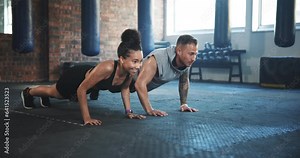Man, woman and push up for gym exercise, training and team workout together on ground. Diversity, friends and performance challenge for fitness, strong core and bodybuilding power in wellness club