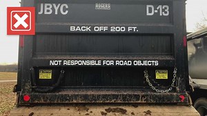 No, signs on the back of a dump truck do not take away legal responsibility for damages