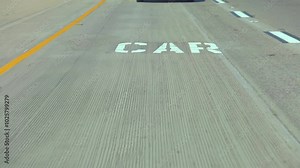 Close-up of road markings on a California highway in slow motion 120fps