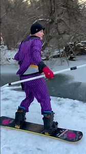 Guys snowboard down the dock and into the frozen lake!