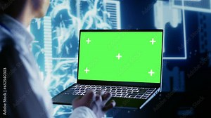 Computer scientist using chroma key laptop to write artificial intelligence script code in startup workplace. Dilligent worker doing maintenance work in data center, updating AI systems