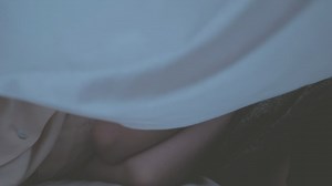 Couple cuddling under a sheet - Free Stock Video