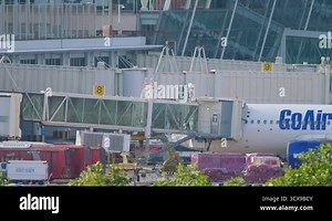 Passengers boarding the airliner through jet bridge
