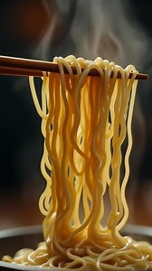 Download Slow Motion Steaming Noodles Lifted with Chopsticks in Cinematic Lighting for free