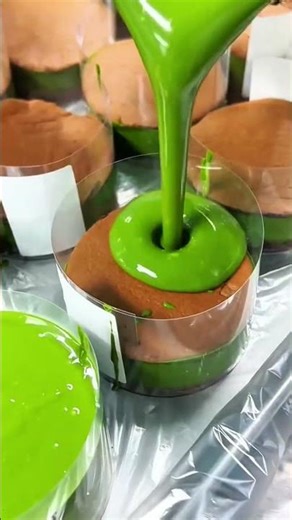 Green sauce pours smoothly over cake, glossy surface spreads evenly