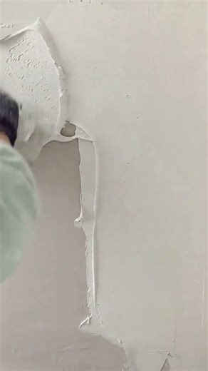 applying wall putty using steel trowel to ensure wall surface is very neat and also clean