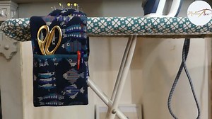 Wanna learn how to make an Ironing Board Organiser,? Watch the video below👇 This hanging caddy fits across the end of your ironing board and has different pockets as well as a pincushion. Perfect for keeping everything handy while pressing. | Madam Sew