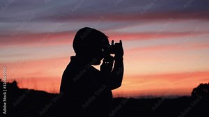 A man taking pictures with his analog camera in a sunset at golden hour
