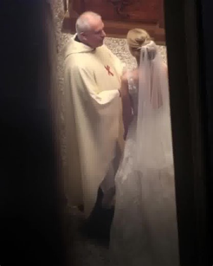I've been a priest for over twenty years and thought I'd seen it all—until this wedding.I t began like any other Saturday ceremony. The groom was cheerful, guests were smiling, music played softly. Then the bride walked in—graceful, beautiful, but something was off. Her smile was forced, her eyes fixed on me, not her groom. Pleading. I asked for their vows. The groom handed his over. When she gave me hers, her hands trembled. I unfolded the paper and froze. Between the lines of her vows were thr
