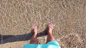 Man's feet washed by sea waves and buried them in the sand Point of view of young man with Bare foot stands on golden sand at sea beach Stock Video