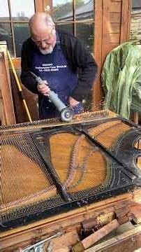 Piano strings being removed off a scrap piano
